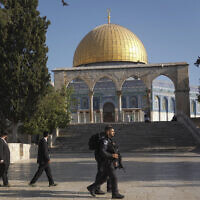 Israeli police officers escort a group of Jewish men to visit the Temple Mount, Aug. 7, 2022. (AP Photo/Mahmoud Illean)