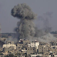 Illustrative: Smoke rises after Israeli airstrikes on a residential building in Gaza, August 7, 2022. (Adel Hana/AP)