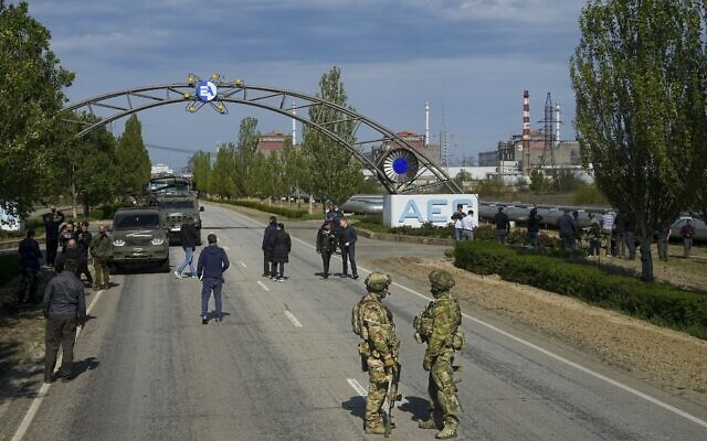 Russian servicemen stand on the road towards the Zaporizhzhia Nuclear Power Station in territory under Russian military control, southeastern Ukraine, May 1, 2022. (AP)