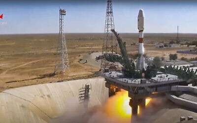 In this handout photo taken from video released by Roscosmos on August 9, 2022, a Russian Soyuz rocket lifts off to carry Iranian Khayyam satellite into orbit at the Russian leased Baikonur cosmodrome near Baikonur, Kazakhstan. (Roscosmos via AP)