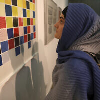 A visitor looks at artworks by the American artist Sol Lewitt while visiting a 19th- and 20th-century American and European minimalist and conceptual masterpieces show at the Tehran Museum of Contemporary Art in Tehran, Iran, Aug. 2, 2022. (Vahid Salemi/AP)