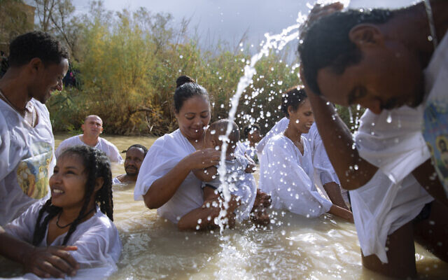 Members of the Eritrean and Ethiopian Christian Orthodox community from Tel Aviv participate in a baptismal ceremony in the waters of the Jordan River as part of the Orthodox Feast of the Epiphany at the Qasr al-Yahud baptismal site, near the West Bank town of Jericho January 19, 2018. (Oded Balilty/AP)