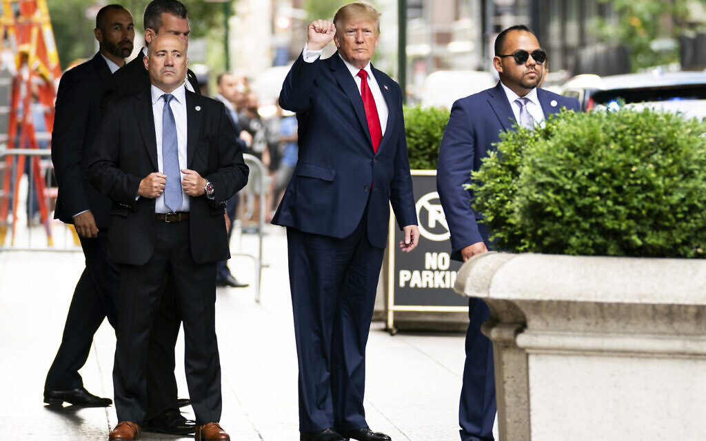 Former US president Donald Trump gestures as he departs Trump Tower, August 10, 2022, in New York, on his way to the New York attorney general's office for a deposition in a civil investigation. (AP/Julia Nikhinson)