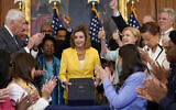 US House Speaker Nancy Pelosi of California, surrounded by House Democrats, poses after signing the Inflation Reduction Act of 2022 during a bill enrollment ceremony on Capitol Hill in Washington, August 12, 2022. (AP Photo/Susan Walsh)