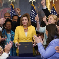 US House Speaker Nancy Pelosi of California, surrounded by House Democrats, poses after signing the Inflation Reduction Act of 2022 during a bill enrollment ceremony on Capitol Hill in Washington, August 12, 2022. (AP Photo/Susan Walsh)
