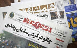 The front pages of the Iranian newspapers, Vatan-e Emrooz, front, with title reading in Farsi: "Knife in the neck of Salman Rushdie," and Hamshahri, rear, with title: "Attack on writer of Satanic Verses," are pictured in Tehran, August 13, 2022. (AP Photo/Vahid Salemi)
