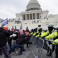 Insurrectionists loyal to then-US president Donald Trump try to break through a police barrier at the Capitol in Washington, Jan. 6, 2021. (Julio Cortez/AP)