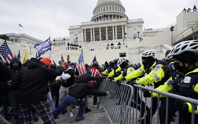Insurrectionists loyal to then-US president Donald Trump try to break through a police barrier at the Capitol in Washington, Jan. 6, 2021. (Julio Cortez/AP)