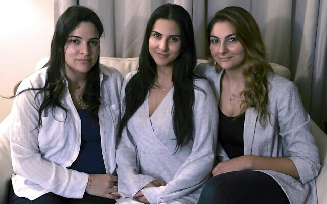 Three of Amer Fakhoury's four daughters, from left, Guila, Macy and Zoya Fakhoury, gather Nov. 5, 2019, in Salem, N.H. Amer Fakhoury was a Lebanese American restaurant owner who made his first trip back to Lebanon in 2019 in nearly 20 years to see family. In Lebanon he was accused of torturing and killing inmates at a former prison where his family says he had worked as a clerk. Fakhoury was released in March 2020 and died that August from lymphoma. (AP/Kathy McCormack, File)