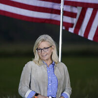 Liz Cheney, a Republican Congresswoman from Wyoming, stands by flags as she waits to speak at a primaries day gathering, Jackson, Wyoming, August 16, 2022. (AP/Jae C. Hong)