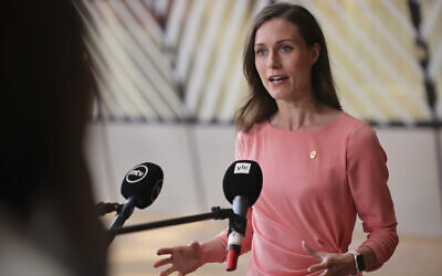 Finland's Prime Minister Sanna Marin speaks with the media as she arrives for an EU summit in Brussels, June 23, 2022. (AP Photo/Olivier Matthys, File)