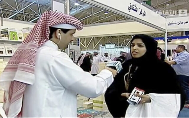 In this frame grab from Saudi state television footage, doctoral student and women's rights advocate Salma al-Shehab speaks to a journalist at the Riyadh International Book Fair in Riyadh, Saudi Arabia, in March 2014. (Saudi state television via AP)