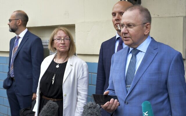 The Jewish Agency's lawyer, Andrei Grishayev, foreground right, and his colleagues speak to journalists after attending a hearing in the trial of the Russian Justice Ministry's request to shutter the organization in the Basmany District Court in Moscow, Russia, on August 19, 2022. (AP Photo)