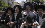 Ultra-Orthodox men react during the funeral of Rabbi Shalom Cohen in Jerusalem, August 22, 2022. (AP Photo/Mahmoud Illean)