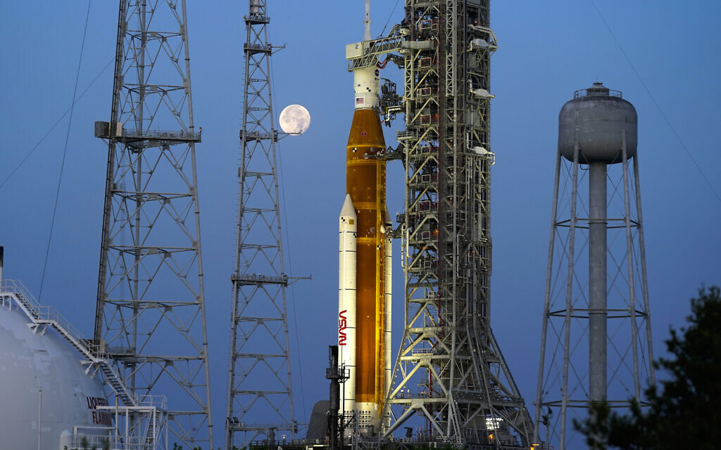 The moon sets in front of the NASA Artemis rocket with the Orion spacecraft aboard on pad 39B at the Kennedy Space Center, Wednesday, June 15, 2022, in Cape Canaveral, Fla. With liftoff planned for Monday, Aug. 29, 2022, the 322-foot rocket will attempt to send an empty crew capsule into a far-flung lunar orbit. (AP/John Raoux, File)