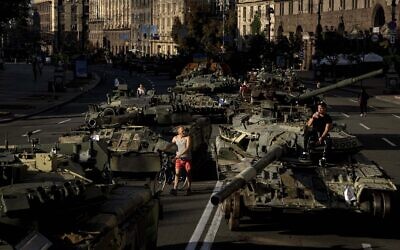 People walk around destroyed Russian military vehicles installed in downtown Kyiv, Ukraine, August 24, 2022. (Evgeniy Maloletka/AP)
