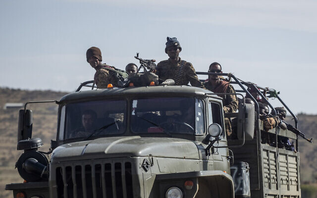 Ethiopian government soldiers ride in the back of a truck on a road near Agula, north of Mekele, in the Tigray region of northern Ethiopia on May 8, 2021. (Ben Curtis/AP)