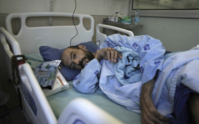Khalil Awawdeh, a Palestinian who has been on a hunger strike for several months protesting being jailed without charge or trial under what Israel refers to as administrative detention, lies in bed at Asaf Harofeh Hospital in Be'er Ya'akov on August 24, 2022. (AP/Mahmoud Illean)