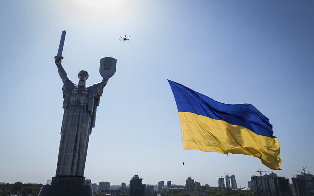 A drone carries a big national flag in front of Ukraine's the Motherland Monument in Kyiv, Ukraine, Aug. 24, 2022. (AP/Evgeniy Maloletka)