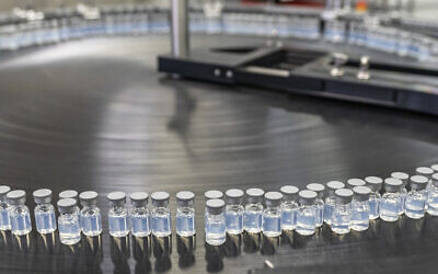 This August 2022 photo provided by Pfizer shows vials of the company's updated COVID-19 vaccine during production in Kalamazoo, Michigan. (Pfizer via AP)