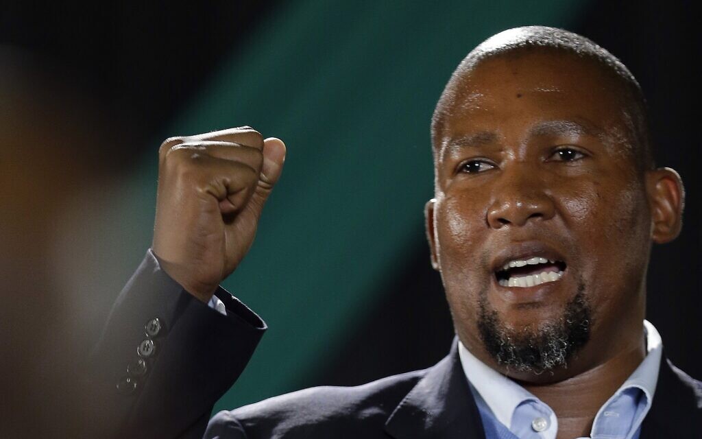 Nelson Mandela's grandson Mandla Mandela clenches his fist as he speaks during a farewell ceremony by the African National Congress at Waterkloof Air Base on the outskirts of Pretoria, South Africa, December 14, 2013. (AP Photo/Themba Hadebe)
