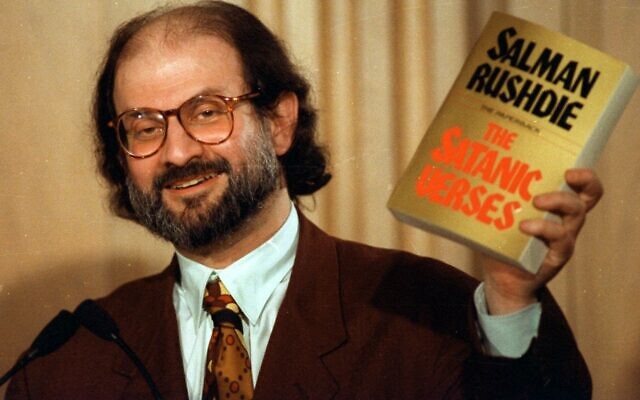 Author Salman Rushdie holds up a copy of his controversial book, "The Satanic Verses" during a 1992 news conference in Arlington, Va.  (AP/Ron Edmonds)