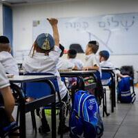 Young students learn in a classroom at the opening of the new school year in a school for ultra-Orthodox Jewish boys in Beit Shemesh, on August 28, 2022. (Yonatan Sindel/Flash90)