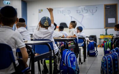 Young students learn in a classroom at the opening of the new school year in a school for ultra-Orthodox Jewish boys, in Beit Shemesh, on August 28, 2022. (Yonatan Sindel/Flash90)