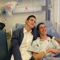 Elazar, 19, (right) and Dovi, 16, (left) are seen at the Hadassah Mount Scopus hospital, after the pair were wounded in a shooting attack in Jerusalem, August 14, 2022. (Courtesy)
