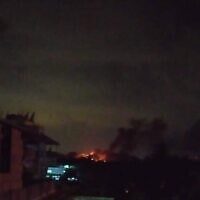 A fire is seen burning near the coastal city of Tartus following a reported Israeli airstrike, August 14, 2022. (Social media)