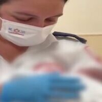 Screen capture from video of MDA medic Monay Jamal with a newborn baby found abandoned on a street in Acre, August 8, 2022. (Channel 12)