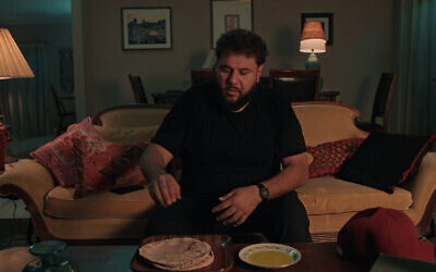 Mo Amer as Mo Najjar, eating olive oil and pita, in an episode of the Netflix series 'Mo.' (Courtesy Netflix)