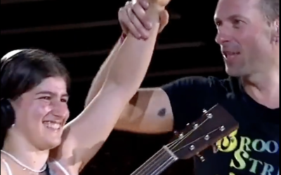 A 15-year-old Israeli girl was invited on stage to perform alongside Coldplay frontman Chris Martin at a concert in Brussels, Belgium, in August 2022 (courtesy)