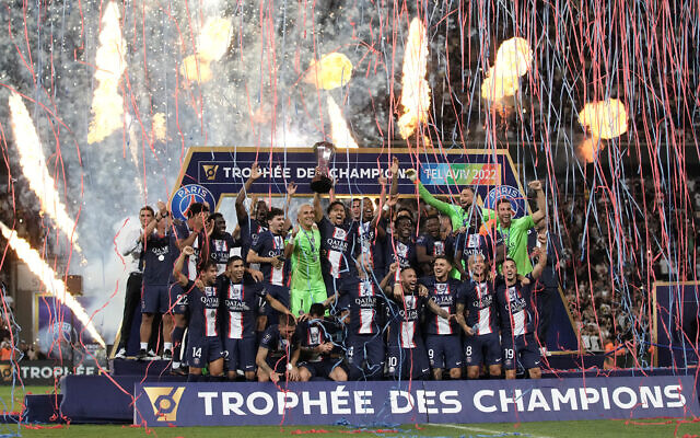 PSG's Marquinhos holds the trophy after winning the French Champions Trophy soccer match between Nantes and Paris Saint-Germain at Bloomfield Stadium in Tel Aviv, July 31, 2022. (AP Photo/Ariel Schalit)
