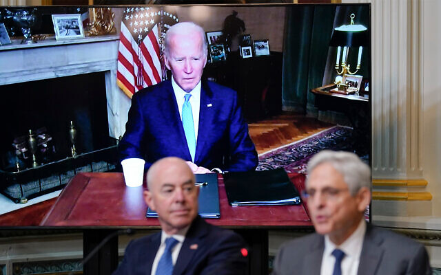 US President Joe Biden listens virtually as Attorney General Merrick Garland, right, speaks during the first meeting of the interagency Task Force on Reproductive Healthcare Access on the White House Campus in Washington, August 3, 2022. Homeland Security Secretary Alejandro Mayorkas looks on. (AP Photo/Susan Walsh)