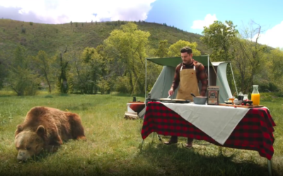 American actor Zac Efron prepares pancakes using Kodiac Cakes mix next to a grizzly bear as part of a promotional video uploaded to his Instagram account on June 14, 2022. (Instagram)