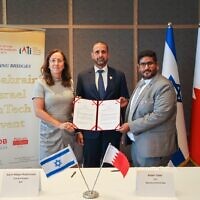 From left: IATI CEO and president Karin Mayer Rubinstein, Bahraini Ambassador to Israel Khaled Yousif Al-Jalahma, and Bahrain Fintech Bay CEO Bader Sater sign a fintech cooperation deal in Tel Aviv, August 2, 2022. (Alon Gilboa)