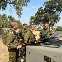Military chief Aviv Kohavi (right) speaks with officials near the border with the Gaza Strip, August 4, 2022. (Israel Defense Forces)