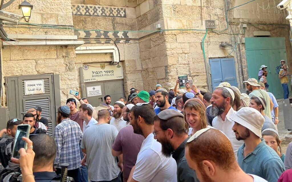 A group of Jewish men shouts the Shema prayer after leaving the Temple Mount, where prayer by non-Muslims is prohibited, August 7, 2022. (Ron Kampeas/JTA)