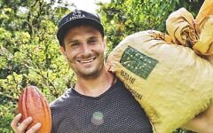Moka Origins CEO Jeff Abella with a cacao pod (right hand) and sack of coffee beans (Courtesy)