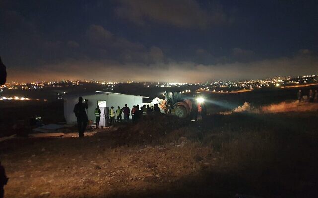Civil Administration personnel and Border Police raze houses at the Ramat Migron illegal settlement outpost and evacuate the residents in the early hours of Monday morning, August 15, 2022. (Courtesy residents of Ramat Migron)