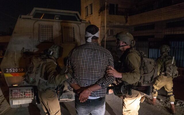 Israeli troops detain a man allegedly affiliated with Palestinian Islamic Jihad in the West Bank, August 7, 2022. (Israel Defense Forces).
