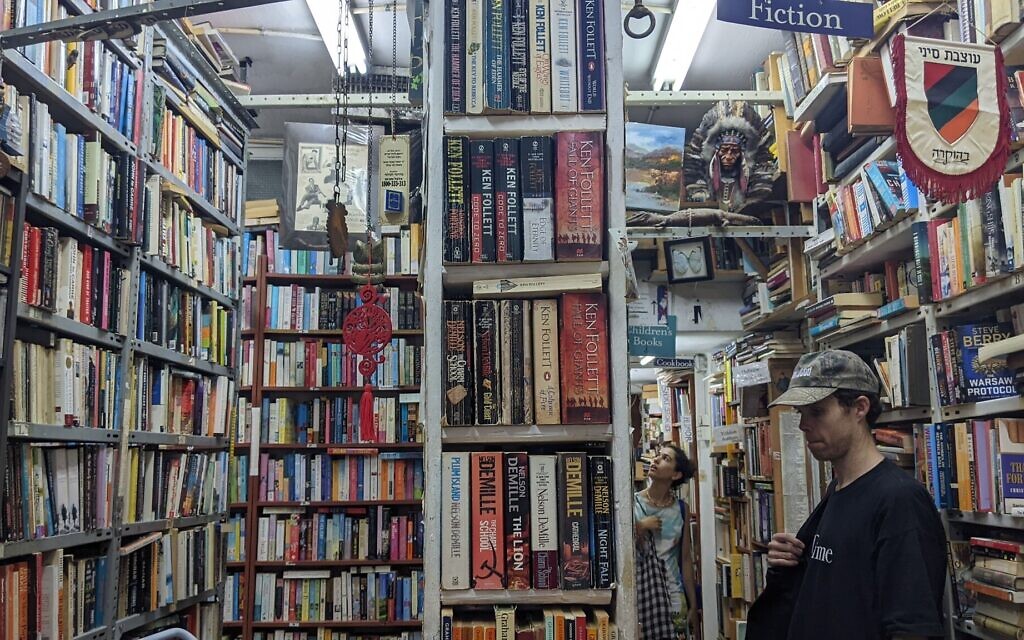 Customers browsing Halper's Bookstore in Tel Aviv on July 6, 2022. (Melanie Lidman/Times of Israel)