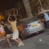 Customers wield chairs during a fight with restaurant staff in Eilat, August 14, 2022. (Screenshot)