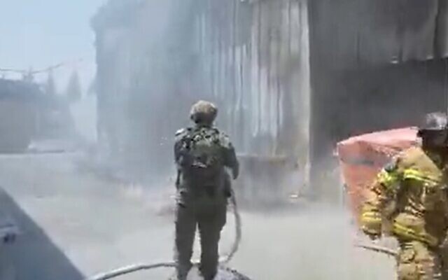 Firefighters work to extinguish blaze caused by rocket strike in southern border community, August 6, 2022 (Screen grab/Twitter)