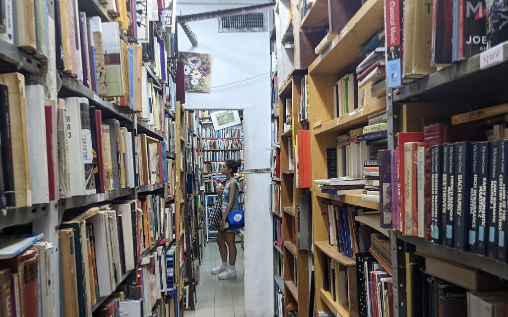 Customers browsing Halper's Bookstore in Tel Aviv on July 6, 2022. (Melanie Lidman/Times of Israel)
