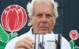 Former handball player Klaus Langhoff, who witnessed the 1972 Munich Olympics hoastage-taking, shows one of his pictures during an AFP interview in Rostock, northeastern Germany, on August 25, 2022. (Tobias Schwarz / AFP)