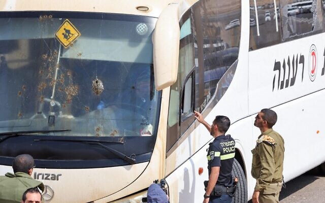 Members of the Israeli security forces and emergency services inspect the site of a shooting attack on a bus transporting soldiers in the Jordan Valley, on September 4, 2022. (Ahmad Gharabli/AFP)
