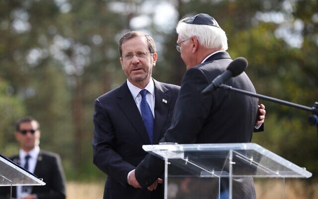 German President Frank-Walter Steinmeier (R) shakes hands wirth Israel's President Isaac Herzog during a visit to Bergen-Belsen Nazi concentration camp where thousands of prisoners from all over Europe were killed during World War II, in Bergen-Belsen near Nordhausen, central Germany, on September 6, 2022. (Ronny Hartmann/AFP)