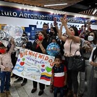 Relatives cheer upon the arrival of crew members of the Venezuelan Boeing 747-300 from Emtrasur Cargo airline at Simon Bolivar International Airport in Maiquetia, La Guaira State, Venezuela, on September 16, 2022. (Federico PARRA / AFP)